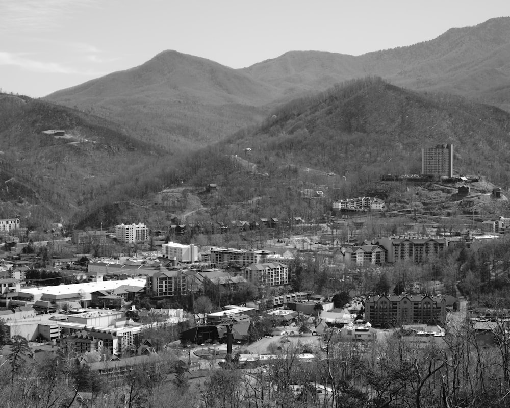 a black and white photo of a city in the mountains