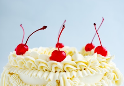 Close-up of a beautifully decorated cake with fresh fruits and cream.