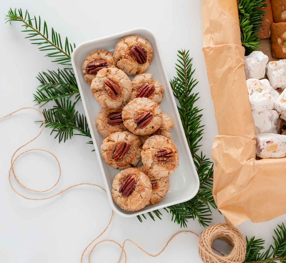 a white tray filled with cookies next to a string of twine