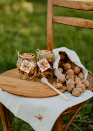 Close-up of a premium mixed nuts jar with golden honey dripping, set on a black and gold background.