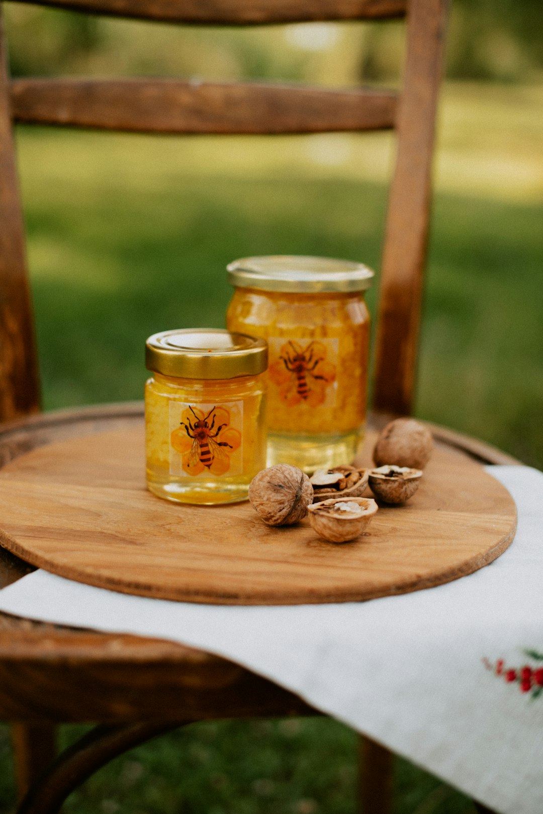 Maple syrup and honey jars on a wooden table