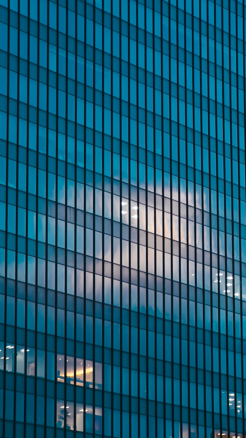 a very tall building with a very cloudy sky in the background