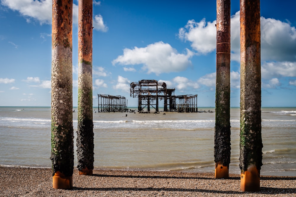 a view of a beach with a pier in the background