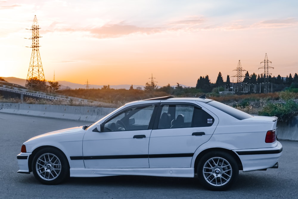 a white car parked on the side of a road