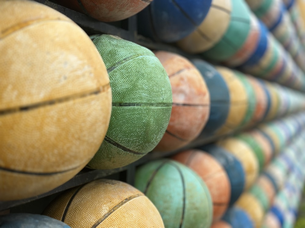 a close up of a bunch of basketballs on a rack