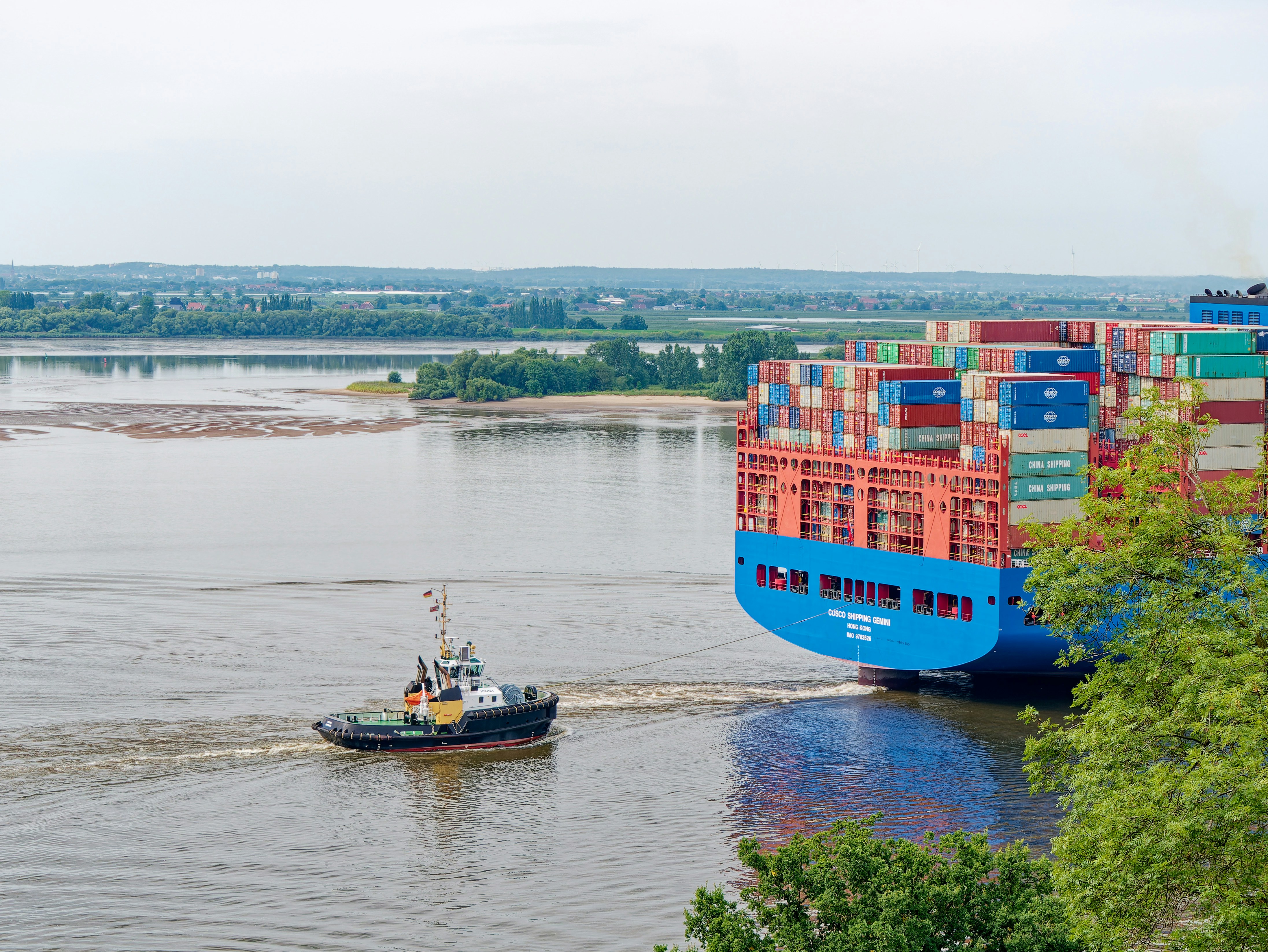 A tug boat pulling a large container ship photo – Free Hamburg Image on ...