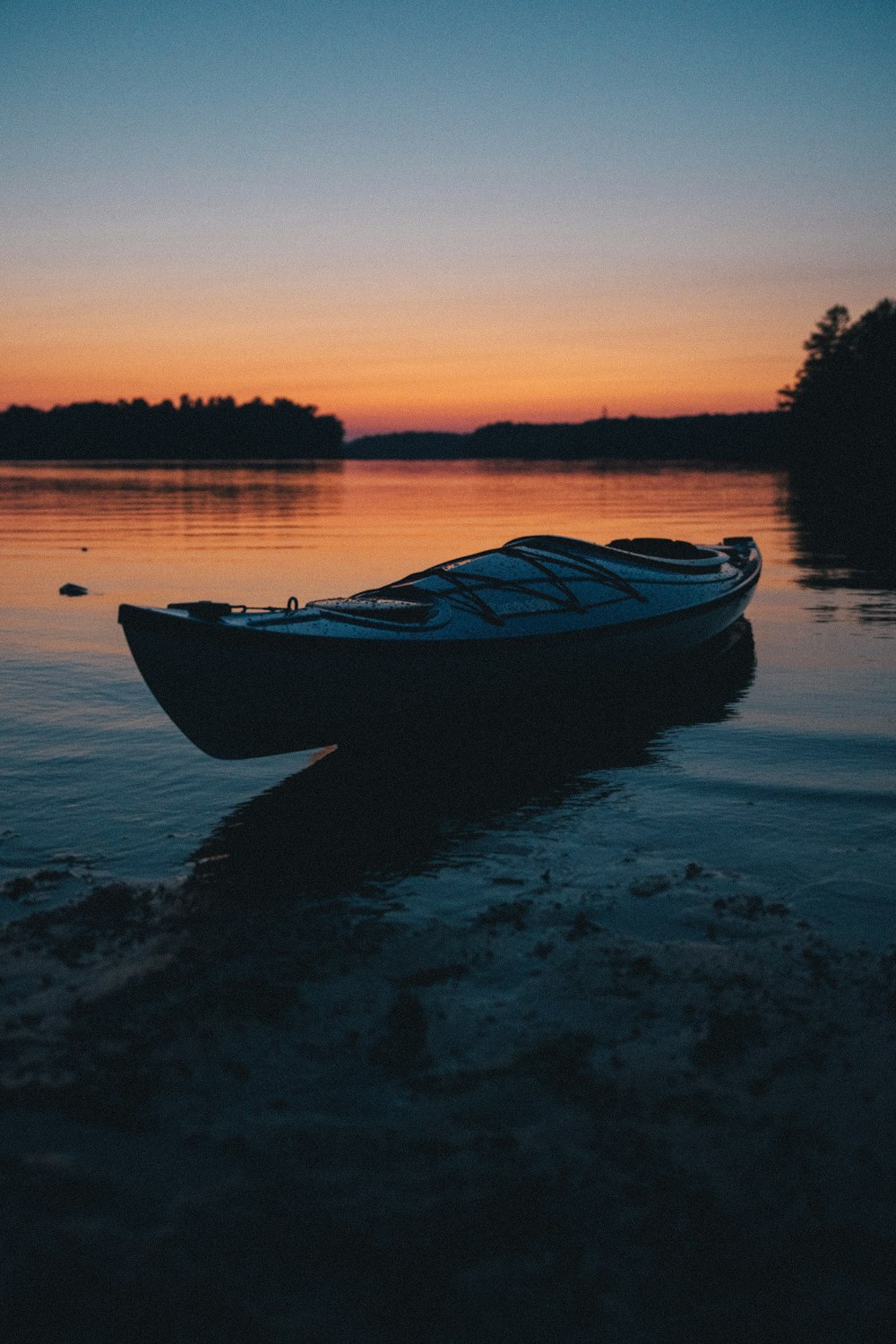 a small boat sitting on top of a body of water