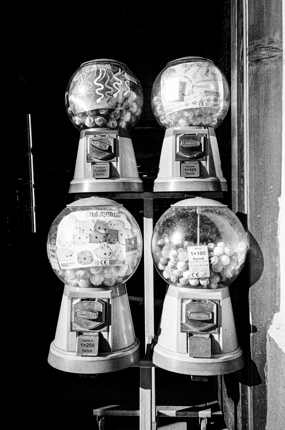 a black and white photo of two gummy machines