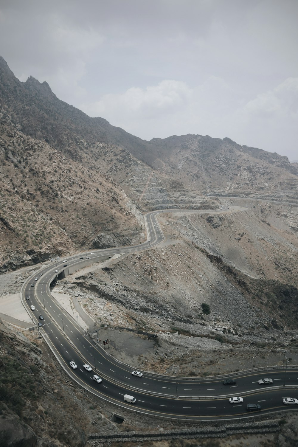 a view of a highway in the middle of a mountainous area