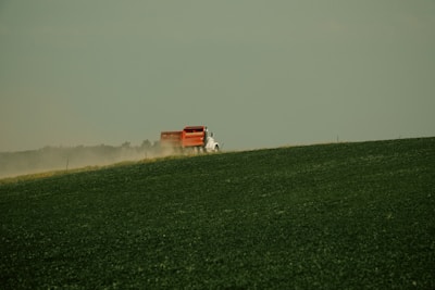 A tractor firmly strapped on a heavy-duty trailer with a scenic Florida highway backdrop.