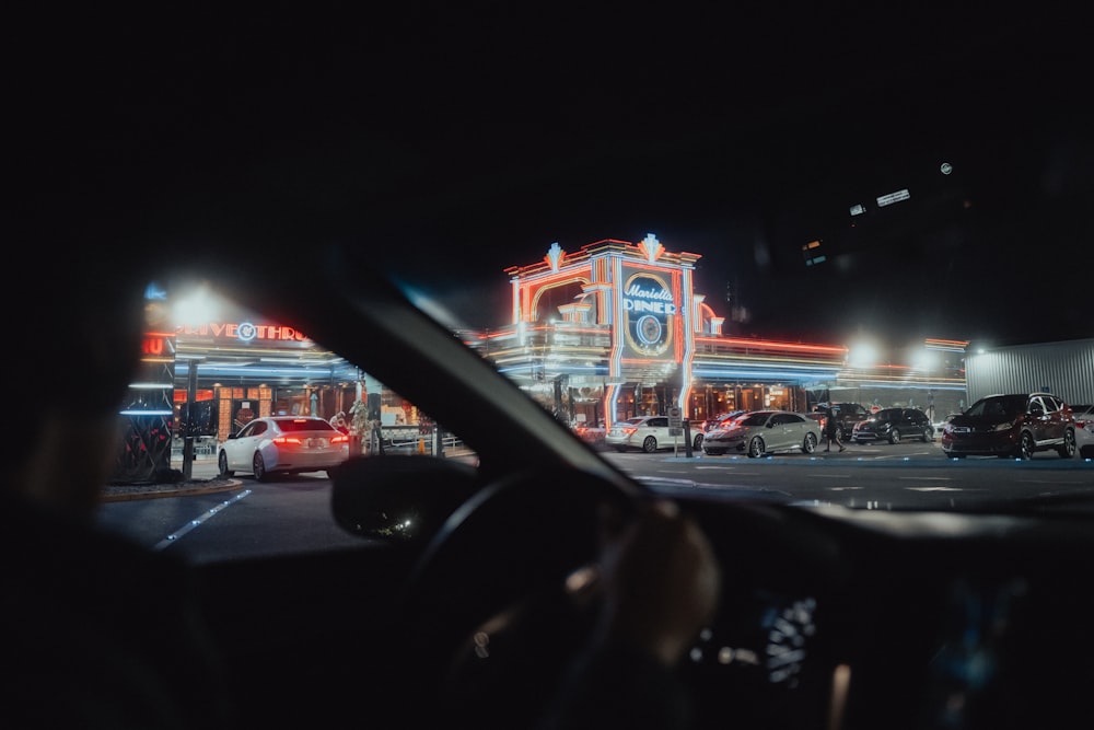 a car driving down a street at night