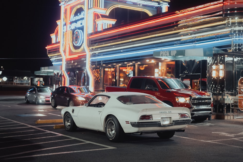 a white car parked in front of a building