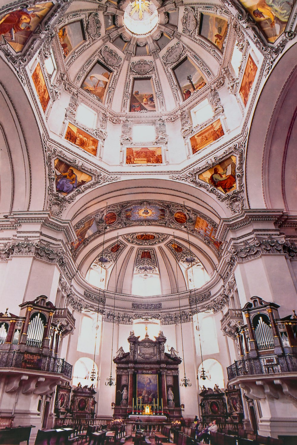 the ceiling of a church with stained glass windows