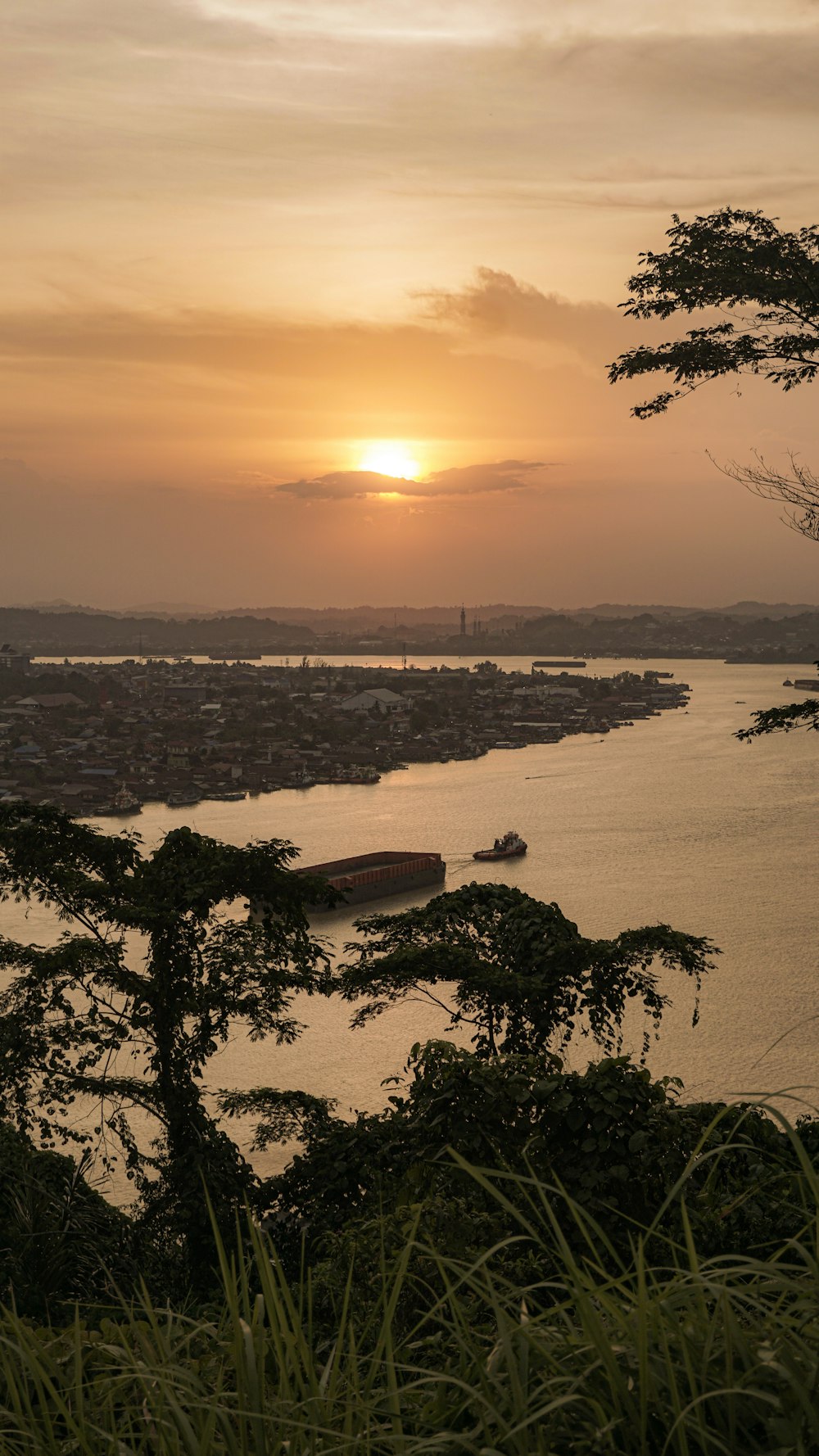 the sun is setting over a body of water