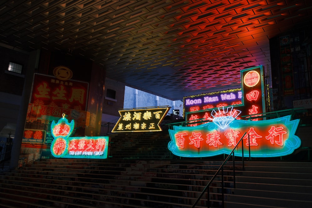 a set of stairs with neon signs on them