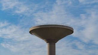 A close-up of a large water tank with a clear blue sky.