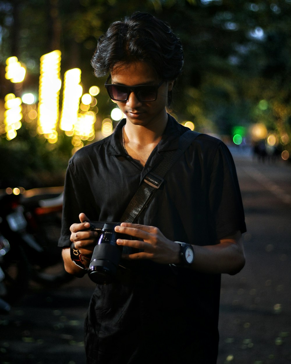 a man standing on a street holding a camera