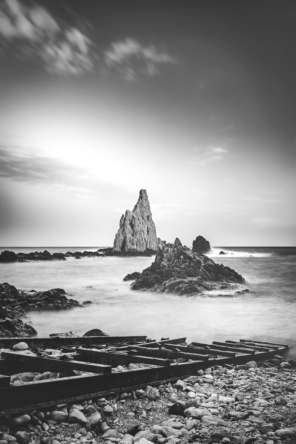 a black and white photo of a rocky beach