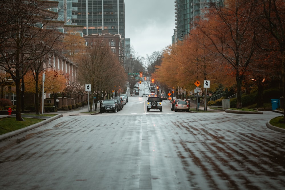 a city street with cars parked on both sides of the street