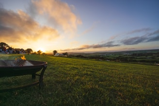 A lively Minecraft landscape showing players building together under a sunset sky.