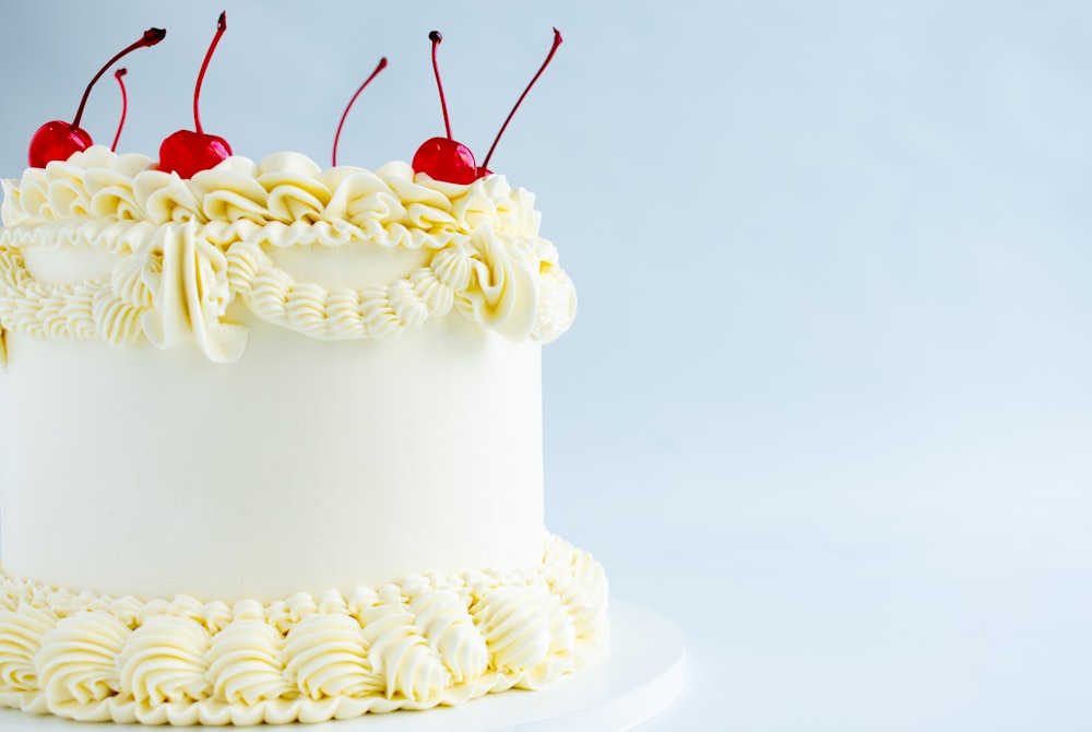 a white cake with two cherries on top of it