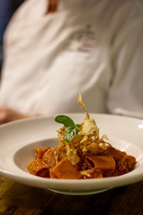 a plate of food with a chef in the background