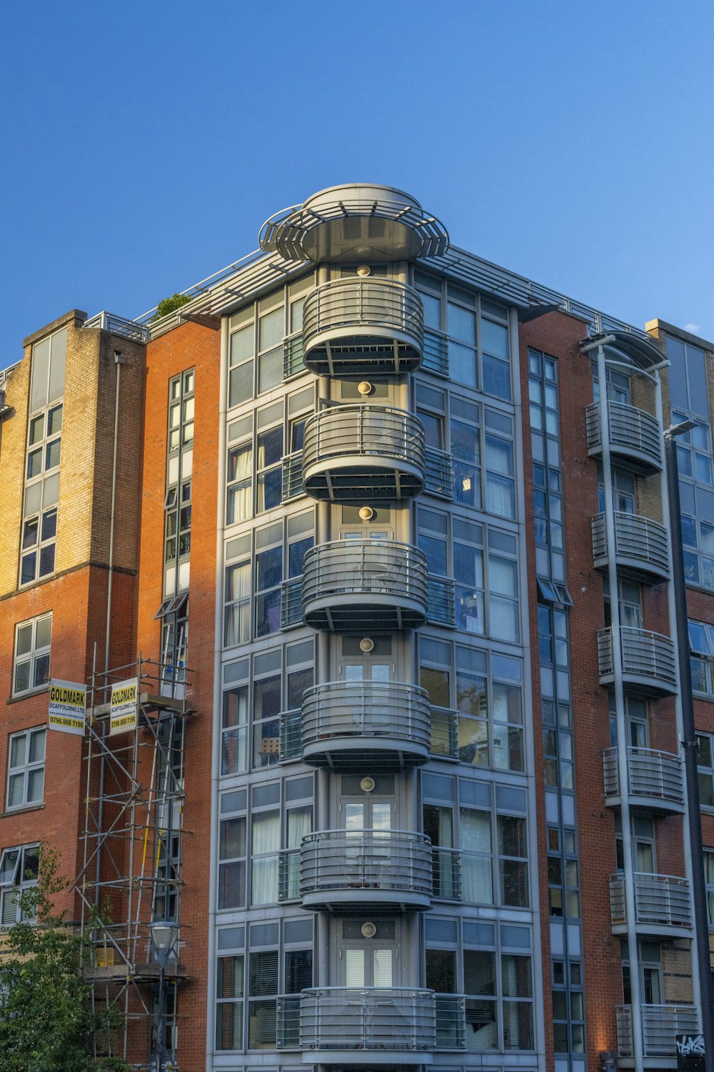 a tall building with balconies on the top of it