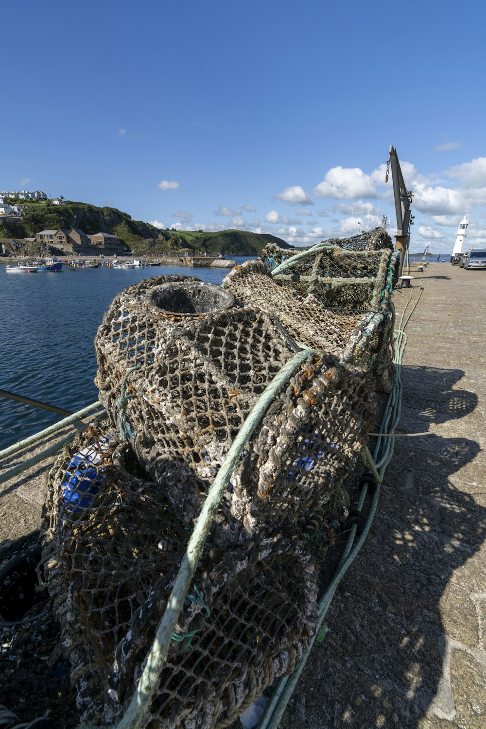 a pile of fishing nets sitting on top of a beach