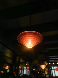 Wi-Fi access point mounted on a stylish living room ceiling with soft lighting.