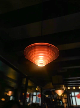 Wi-Fi access point mounted on a stylish living room ceiling with soft lighting.