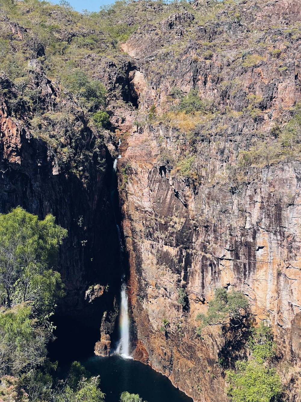 a waterfall in the middle of a canyon