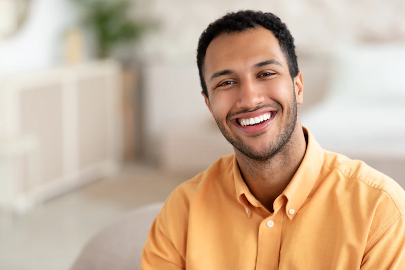 relaxed mature man smiling on a living room couch