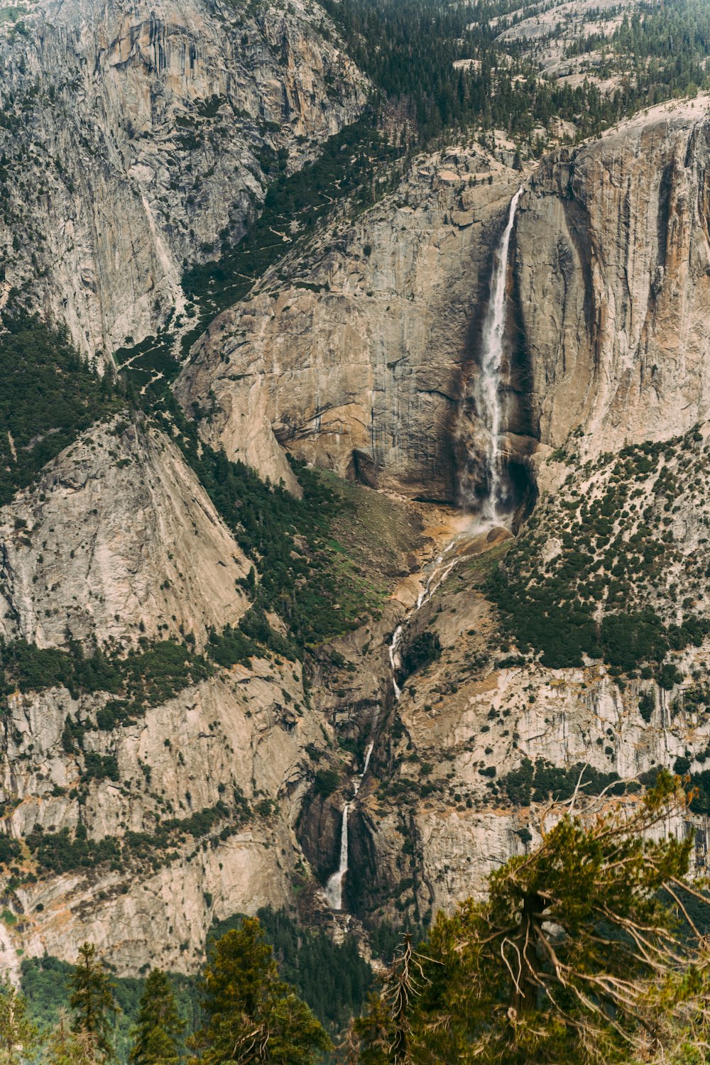 a view of a waterfall from the top of a mountain