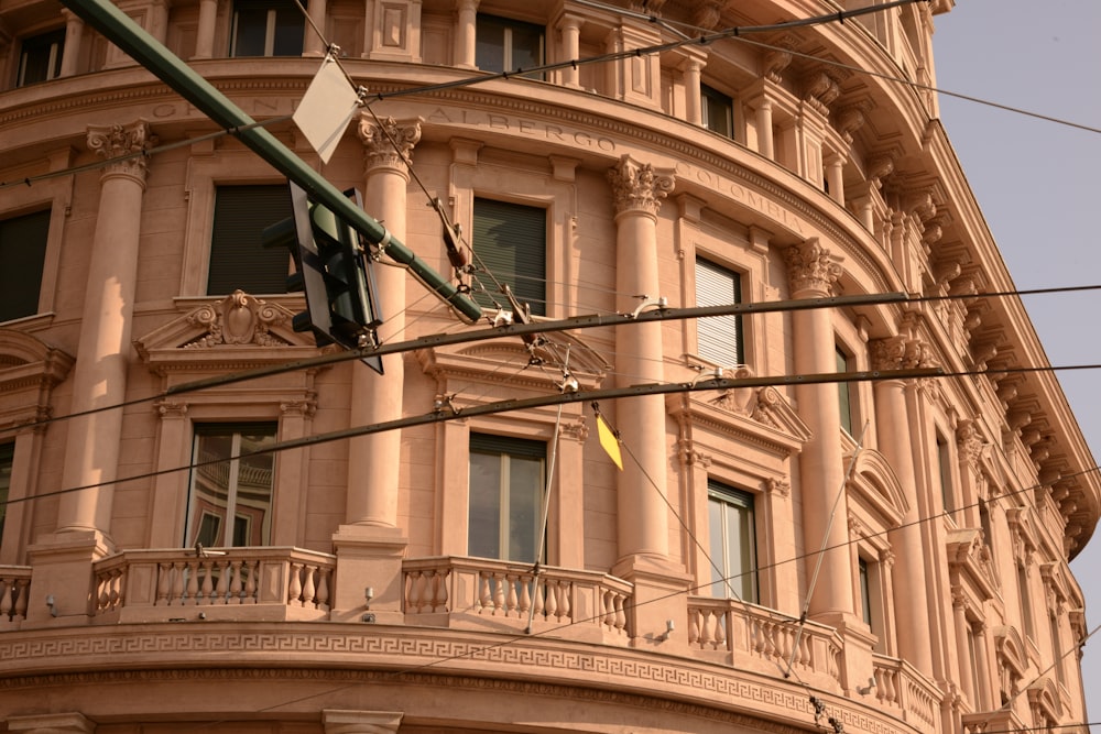 a traffic light hanging from a pole in front of a building