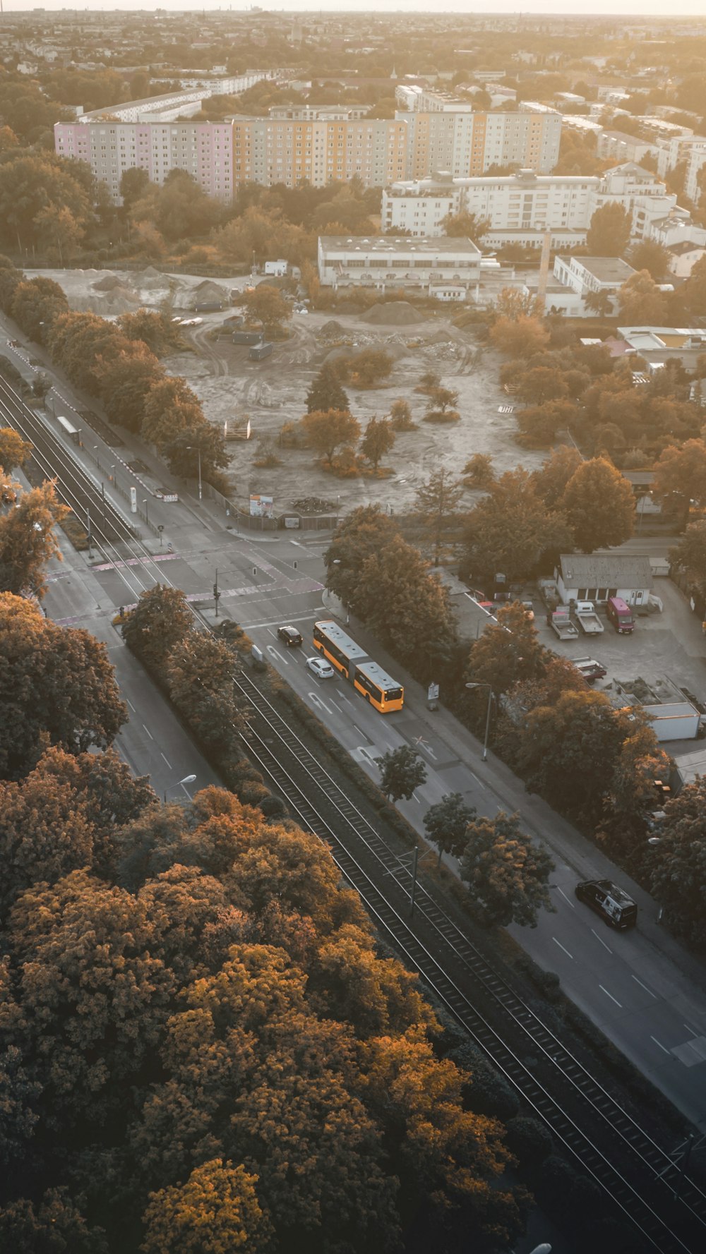 an aerial view of a city with a bus on the road