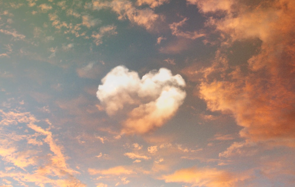 a heart shaped cloud is in the sky