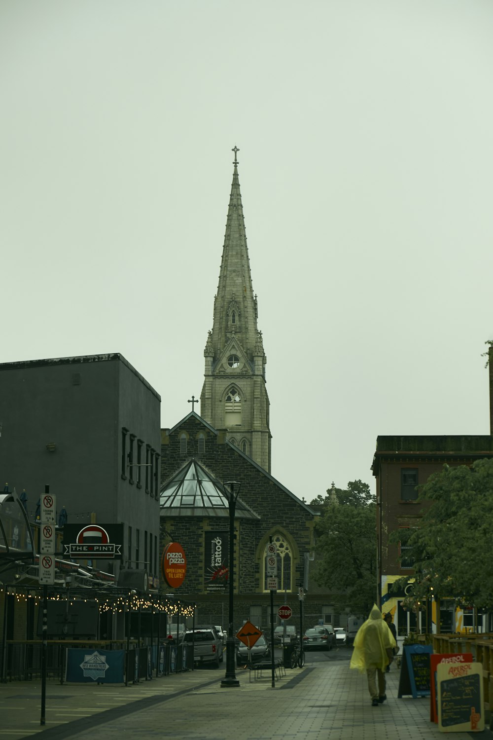 a person walking down a street in front of a church