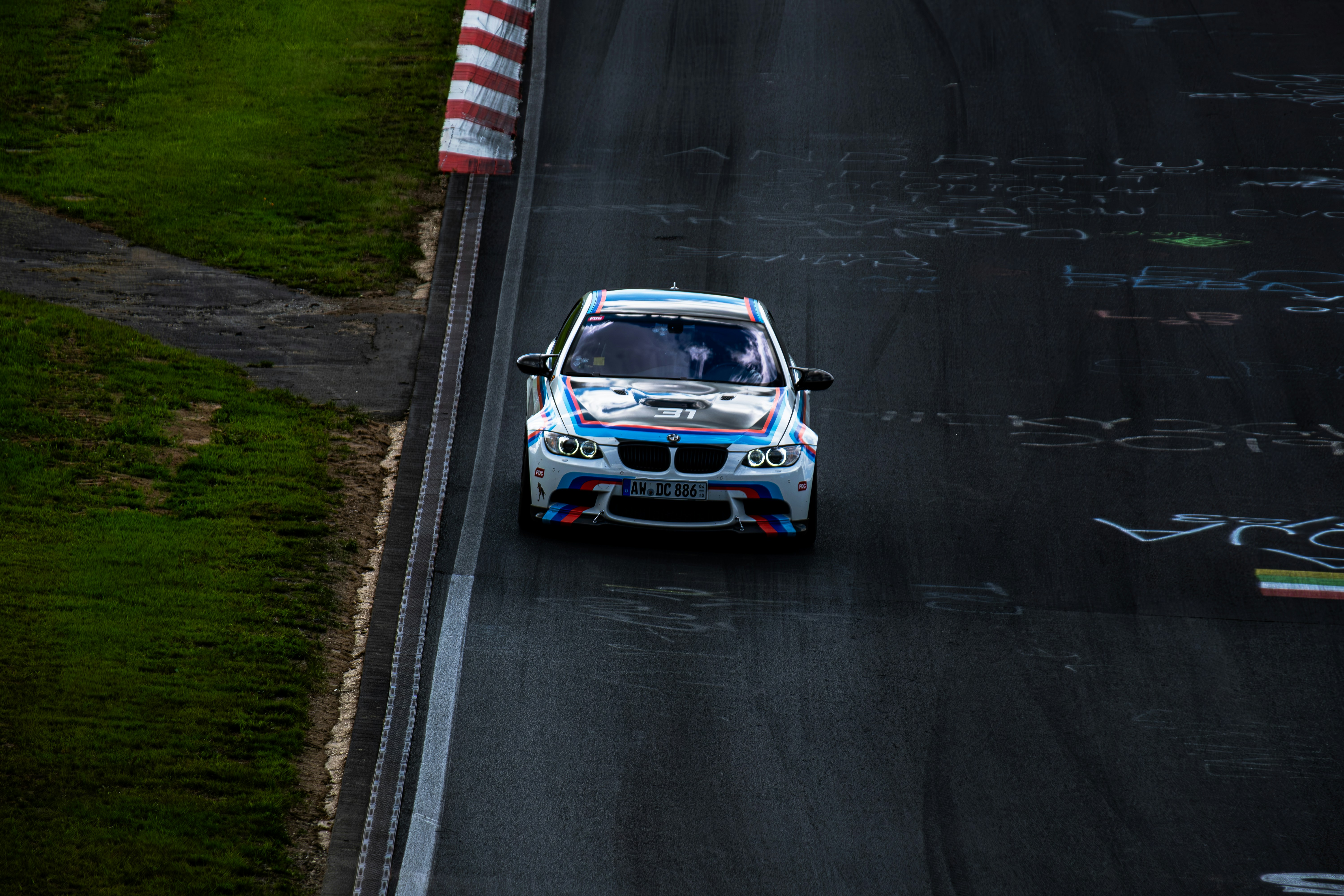 a white car driving down a race track, 