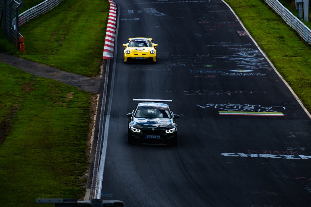 two cars driving on a race track near each other