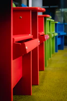 A collection of colorful chairs lined up in a creative studio space, ready for use.