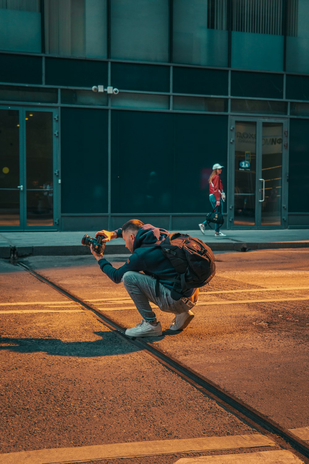 a man with a backpack and skateboard on a street