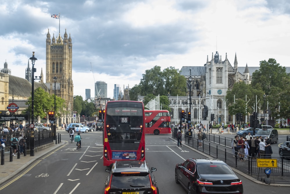 a red double decker bus driving down a street