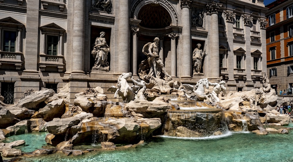 a large building with a fountain in front of it