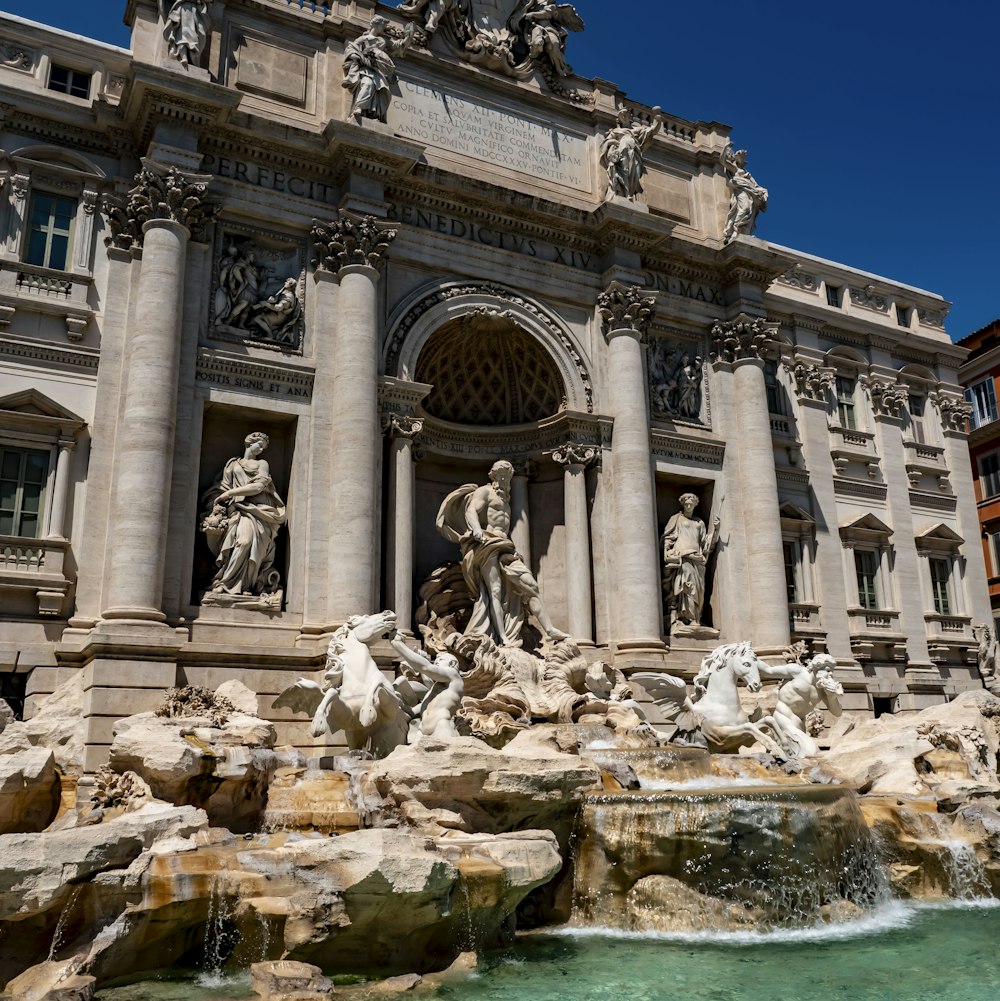 a large building with a fountain in front of it