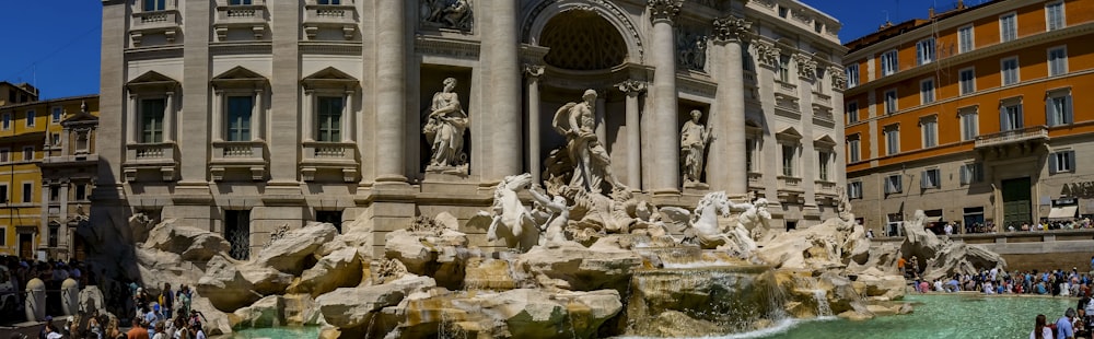 a large building with a fountain in front of it