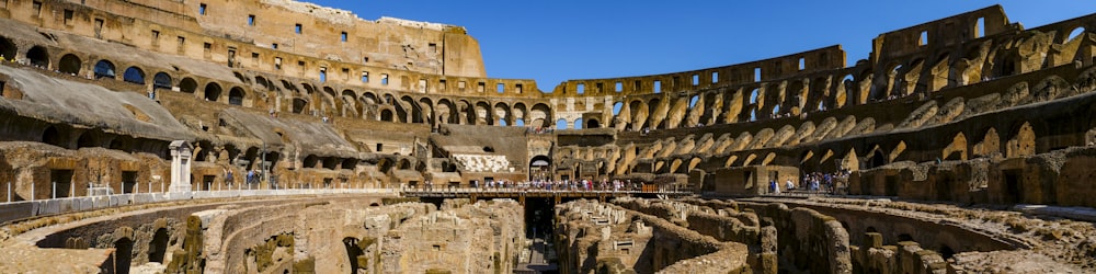 the interior of a roman colossion with people walking around