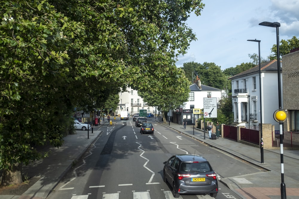 a city street with cars parked on both sides of the street