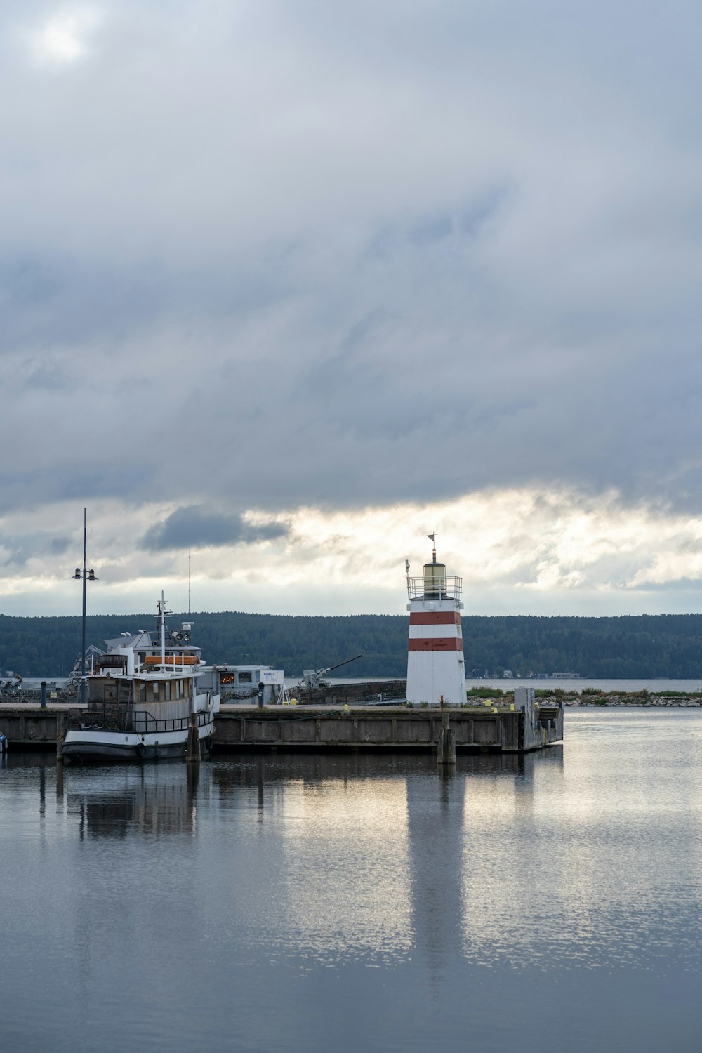 a light house sitting on top of a pier next to a body of water