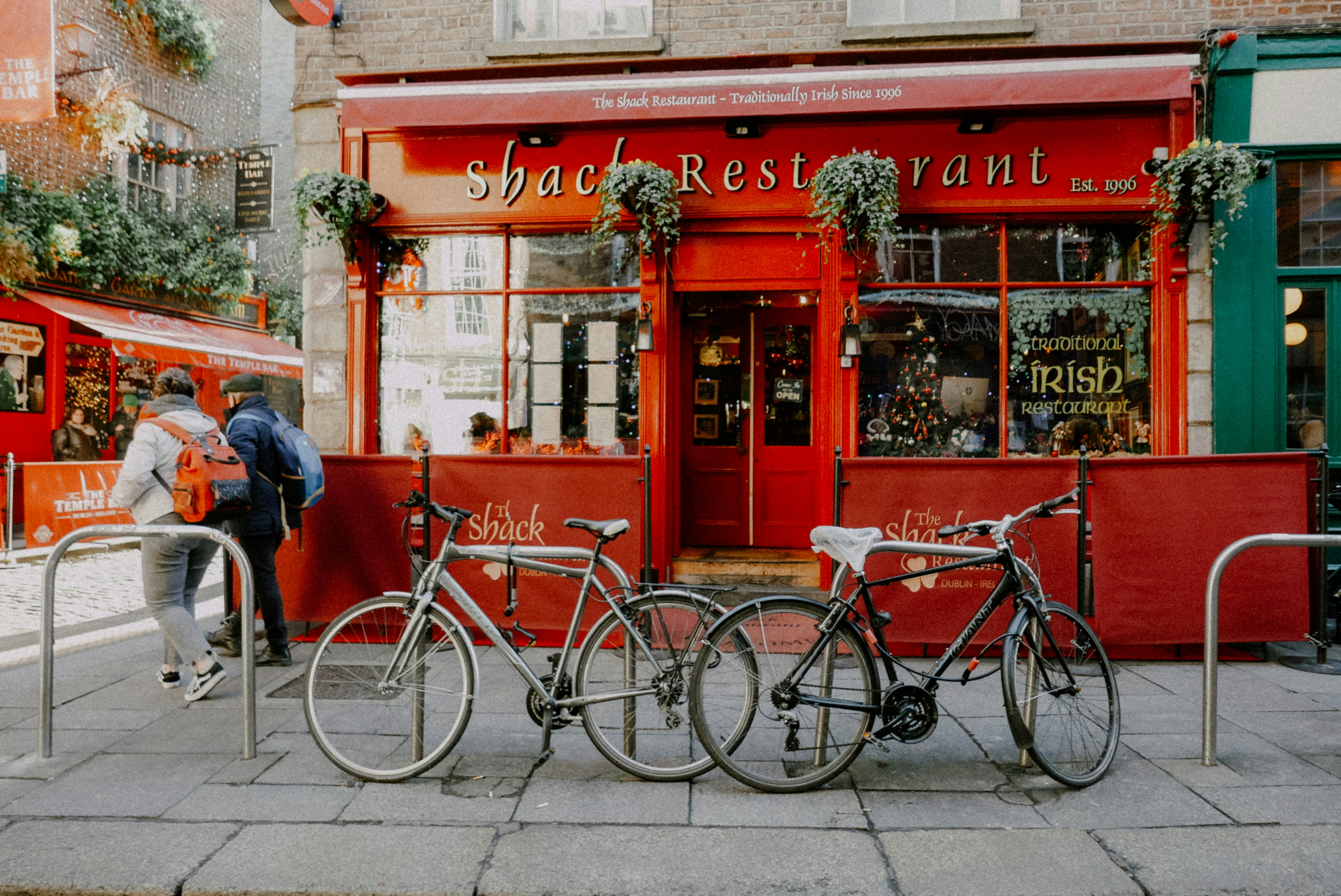 a couple of bikes parked next to each other on a sidewalk
