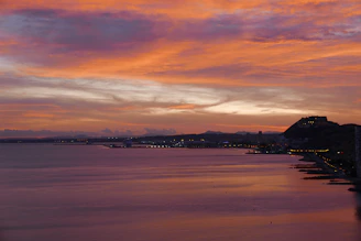 Sunset view over the coast of Santa Catarina with city lights beginning to glow.